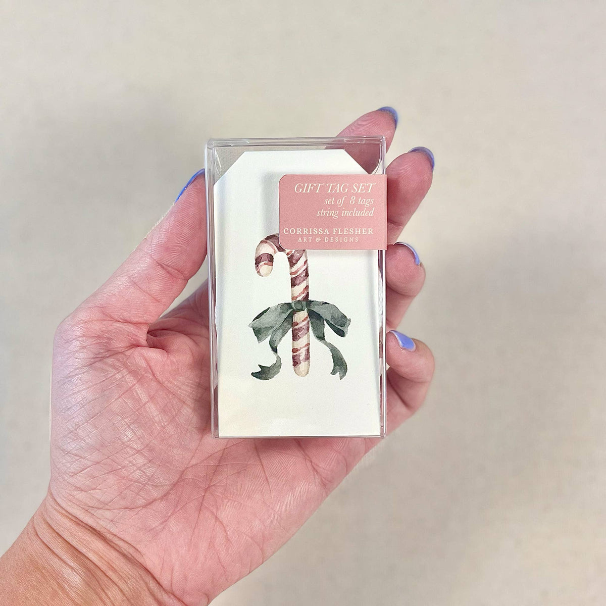 Gift tag set in clear plastic packaging with candy cane and holly tag