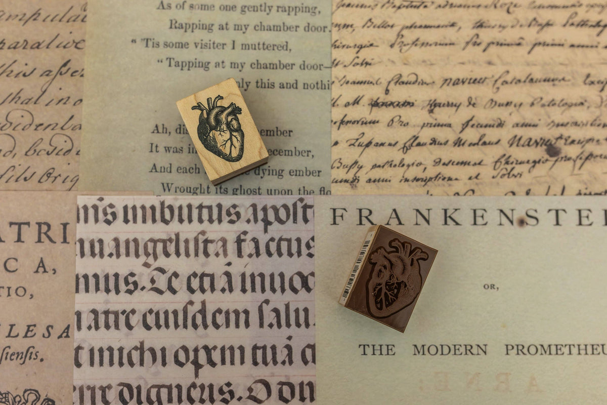 Wooden stamp block with carved dragon-like crest design on paper