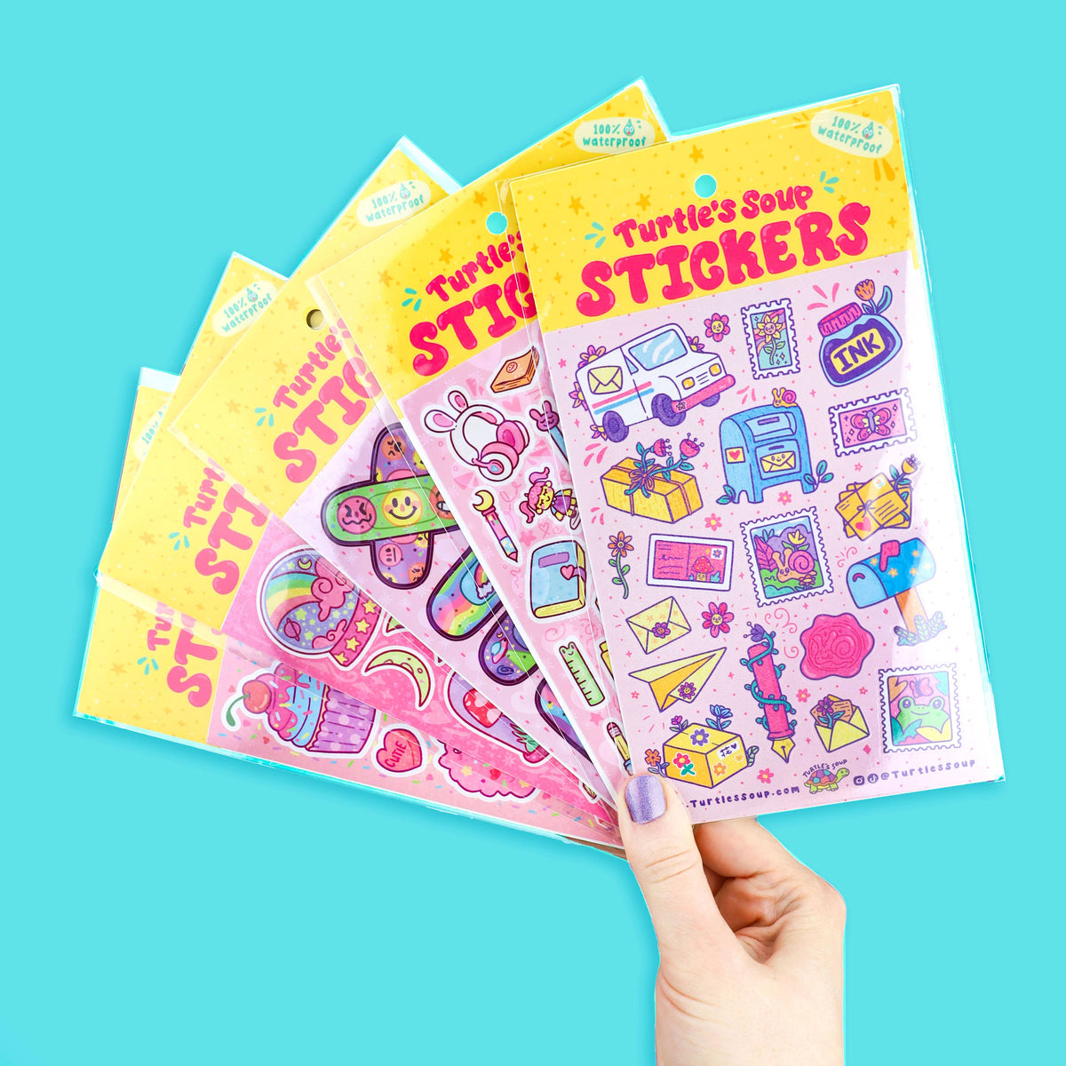 Hand holding multiple glitter sticker sheets with stationery and animal illustrations