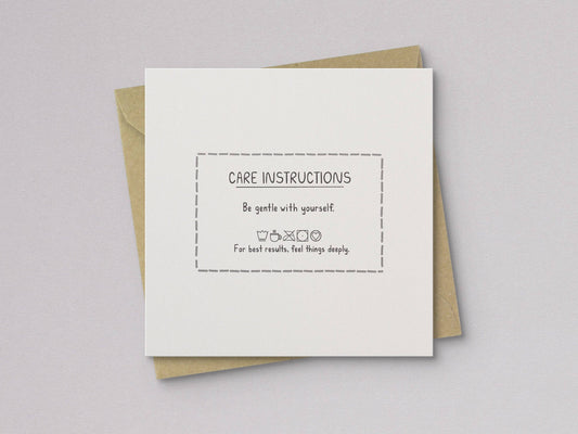 Care instructions card with dashed border and small heart icons, backed by kraft paper