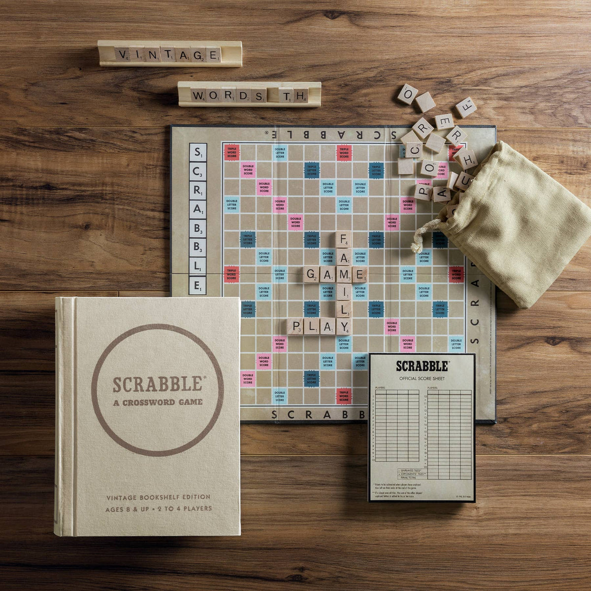 Scrabble game board and letter tiles with cloth pouch on tabletop