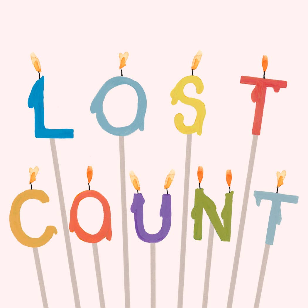 Close-up of Lost Count candles spelling letters on greeting card