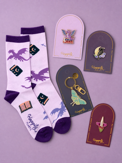Assorted dragon pin cards and matching enamel pins with hanging loops