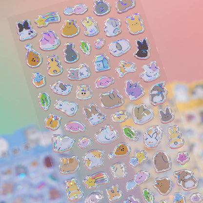 Holographic animal sticker sheet with small bunny, cat, and heart icons on a pink background