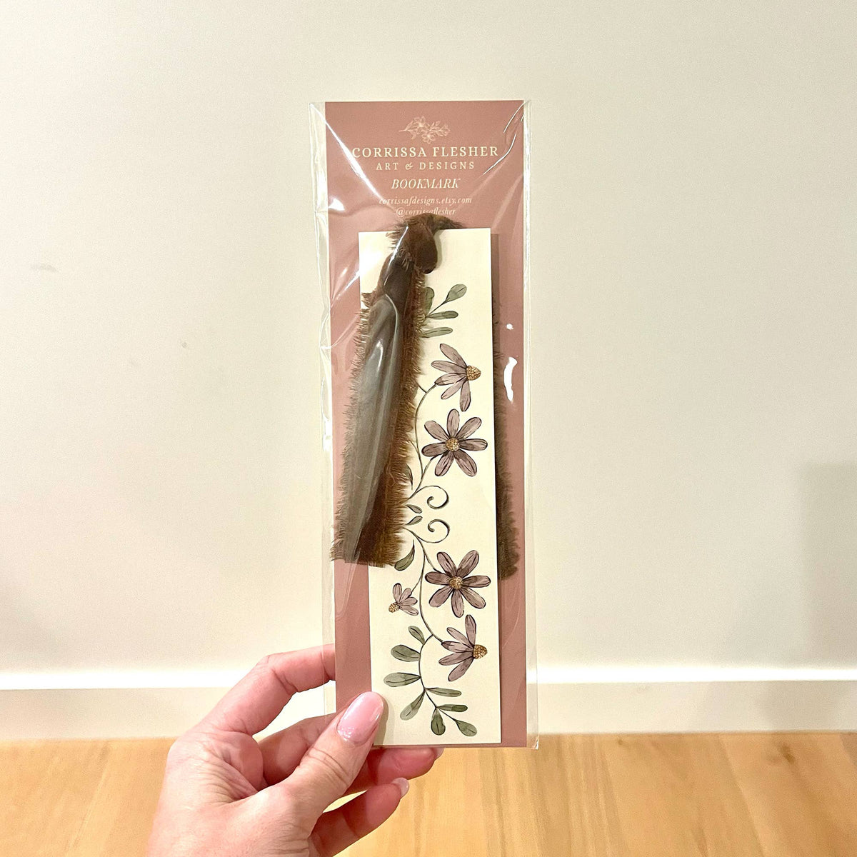 Packaged double-sided bookmark featuring purple floral design and dark velvet ribbon