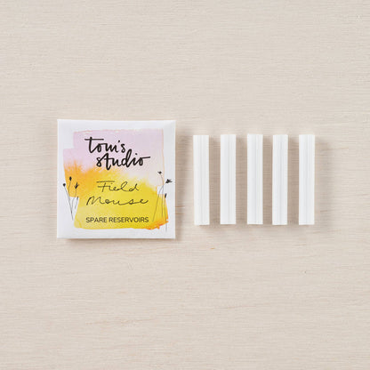Spare ink reservoir set in white plastic sleeves, with branded paper pouch