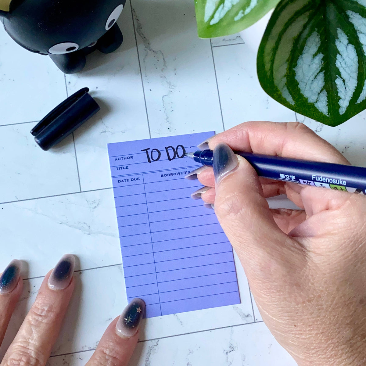 Purple library card mini notecard with ruled fields and a handwritten note