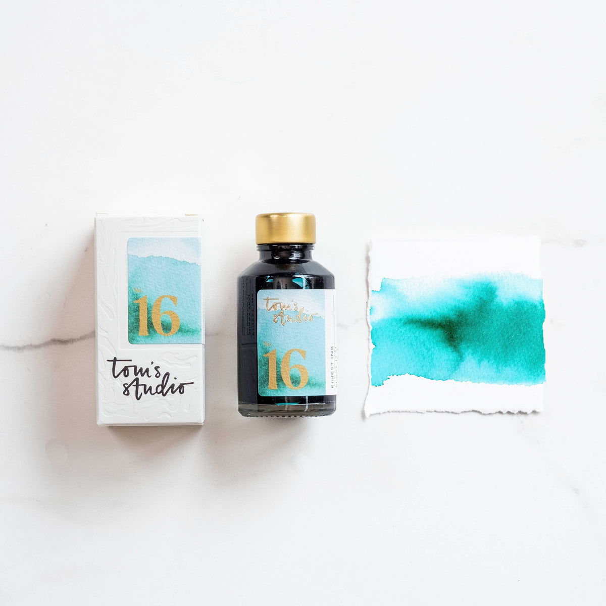 Bottle of sunny teal fountain pen ink with matching color swatch and box