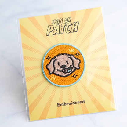 Round embroidered dog iron-on patch with orange dog face on orange background