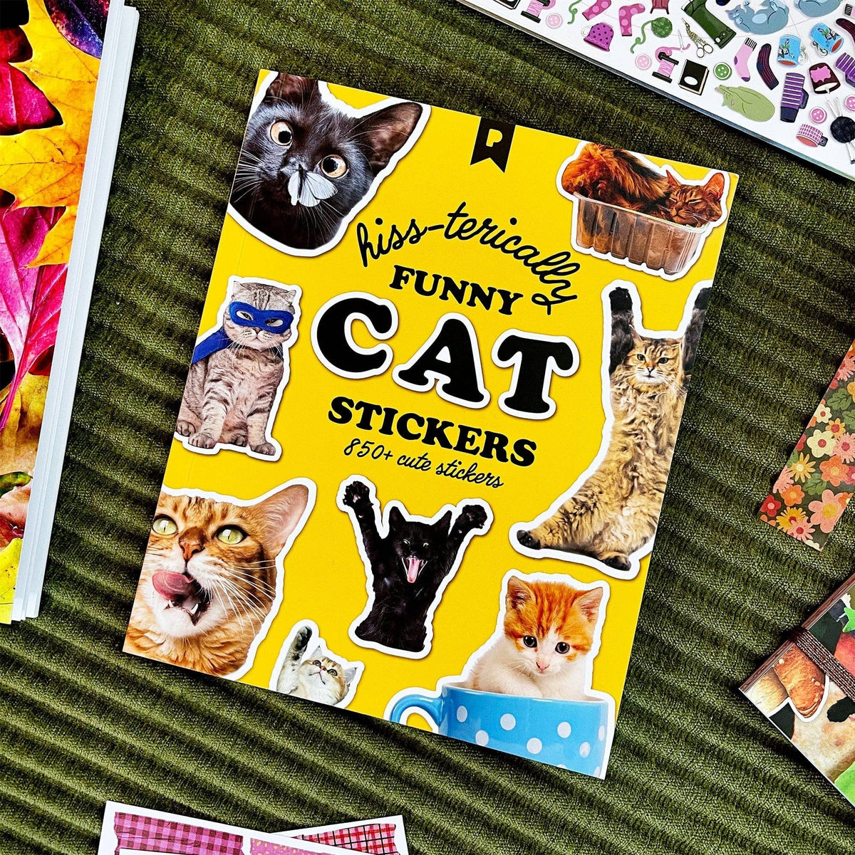 Cat sticker book lying open with yellow “Funny Cat Stickers” cover and multiple cat stickers