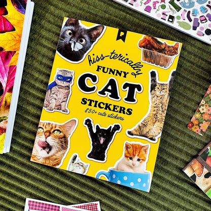Cat sticker book lying open with yellow “Funny Cat Stickers” cover and multiple cat stickers