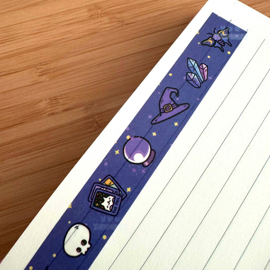 Witchy-themed washi tape strip with skull, cauldron, and crystal icons in purple-blue