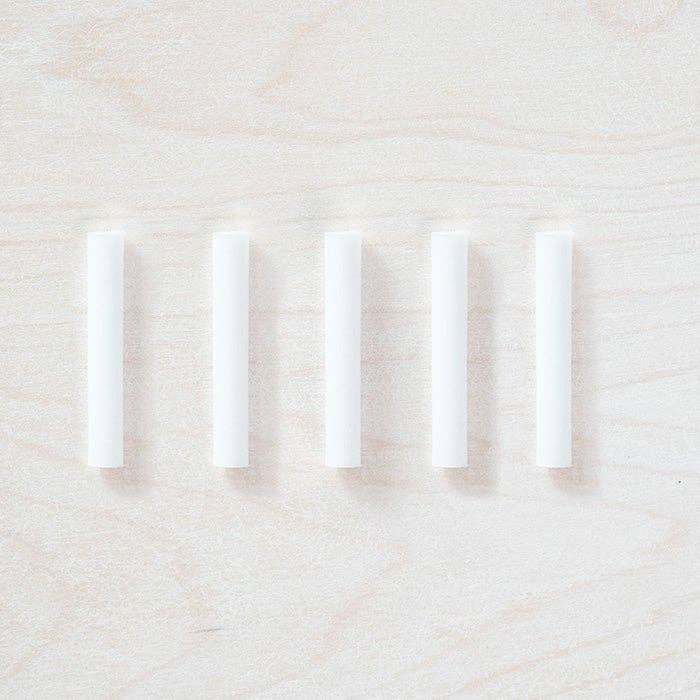 Five white spare ink reservoir tubes