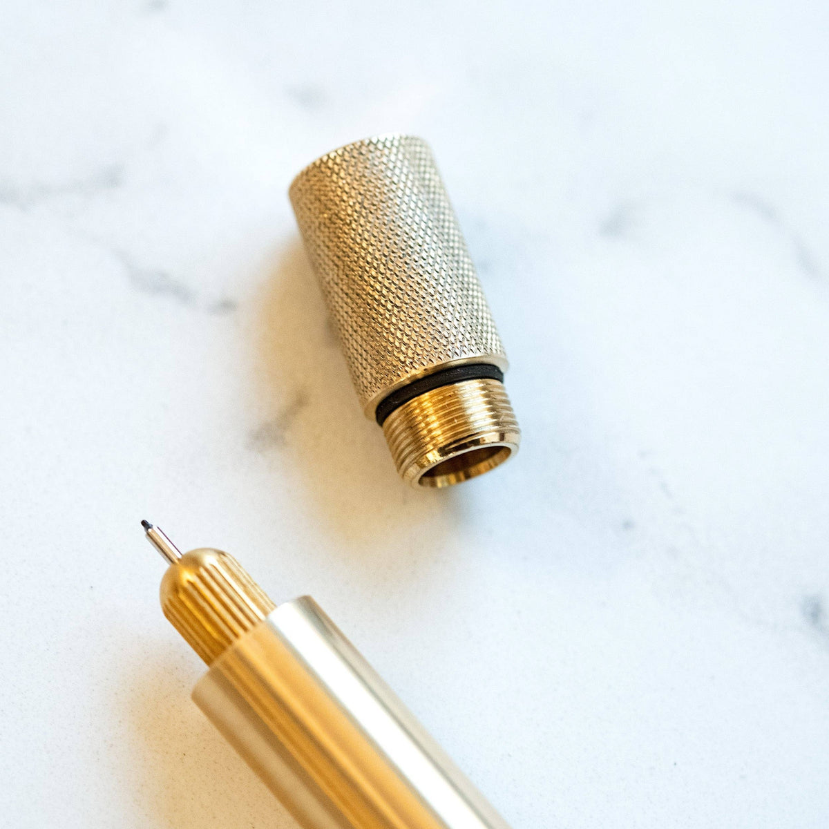 Brass pen with textured grip sleeve and pointed nib