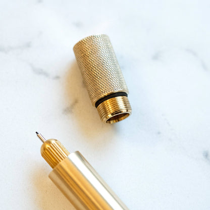Brass pen with textured grip sleeve and pointed nib