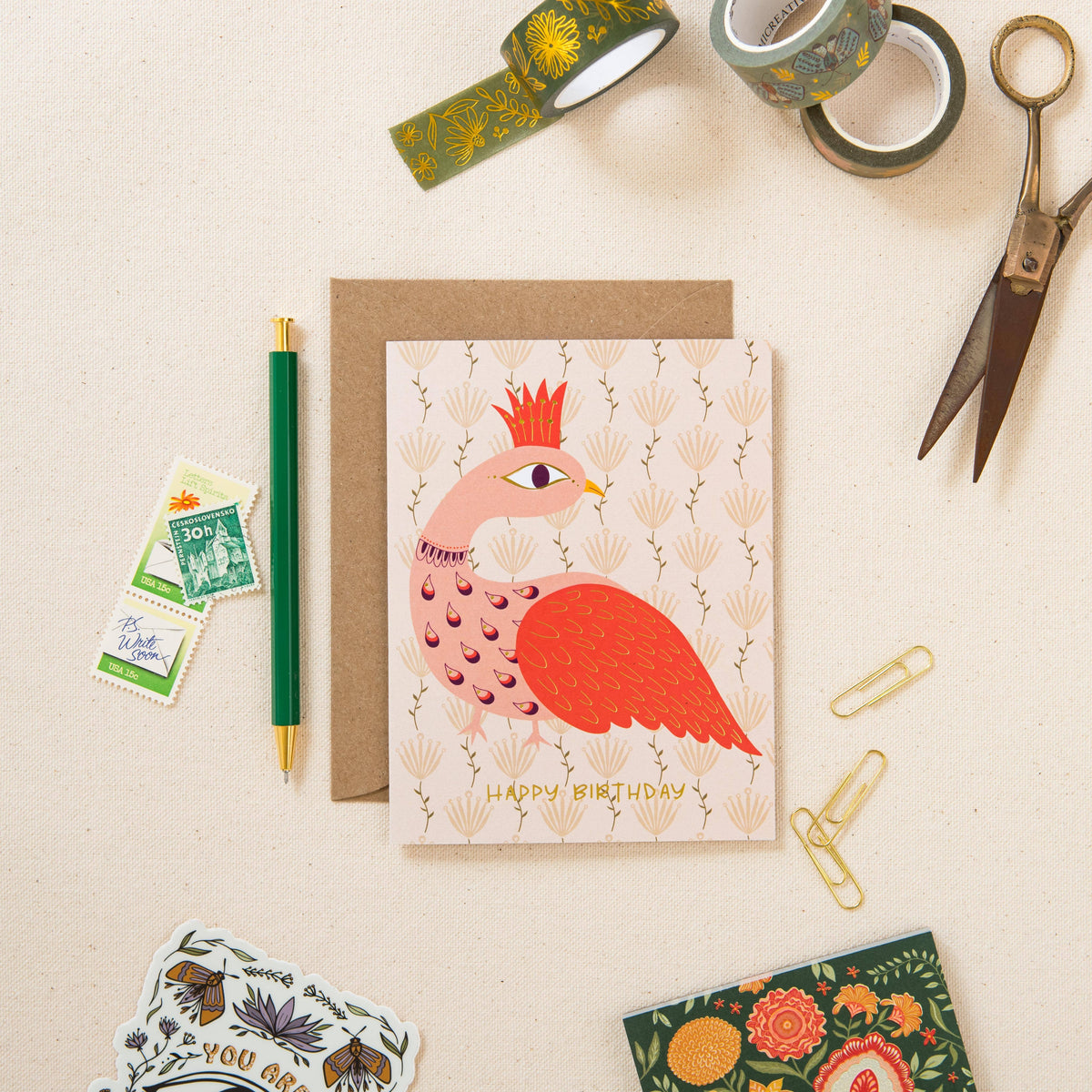 Peacock birthday greeting card with gold foil details and matching brown envelope