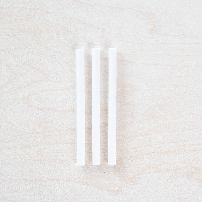 Three white spare ink reservoir tubes