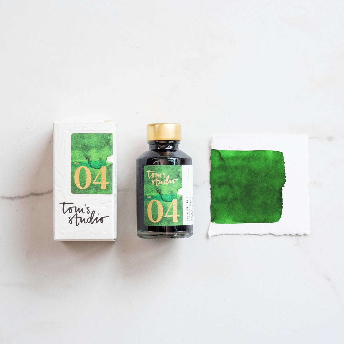 Fountain pen ink bottle with gold cap, green ink swatch and boxed 04 label
