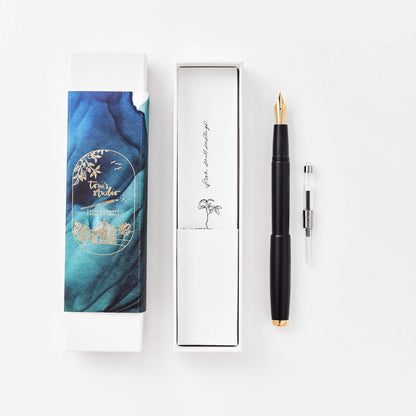Black fountain pen in gift box with spare nib cartridge.