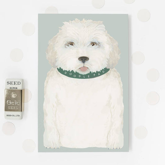 Dog-illustrated notepad with white dog cover and green "DOODLE PAW" band