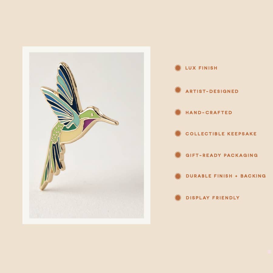 Hummingbird pin shown on a presentation card with colorful enamel details.