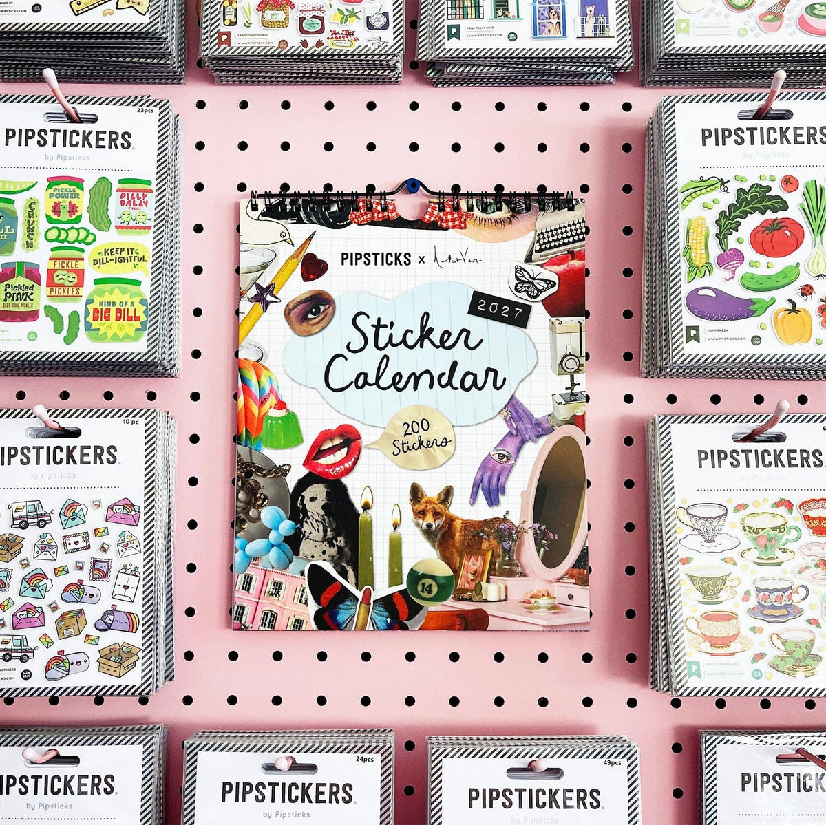 Wall calendar display with multiple sticker calendars, each with a spiral binding and cover art.