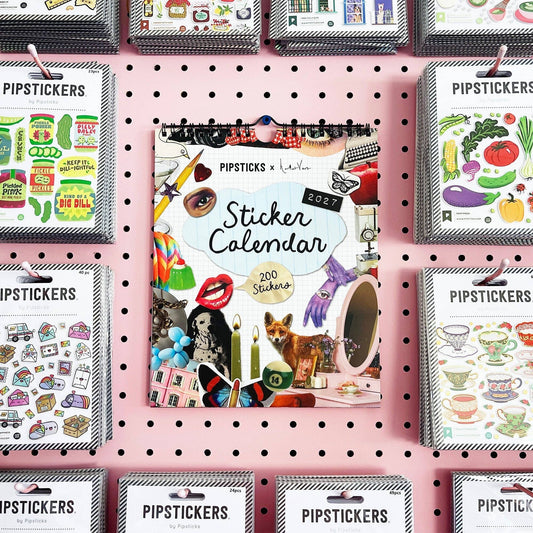Wall calendar display with multiple sticker calendars, each with a spiral binding and cover art.