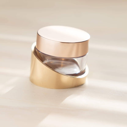 Tilt ink pot holder with gold base, clear glass insert, and white lid closed