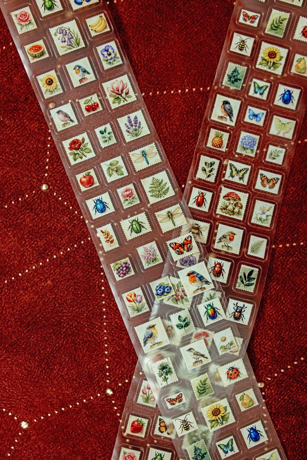 Transparent tape featuring mini postage stamps in square blocks, shown laid across the scene