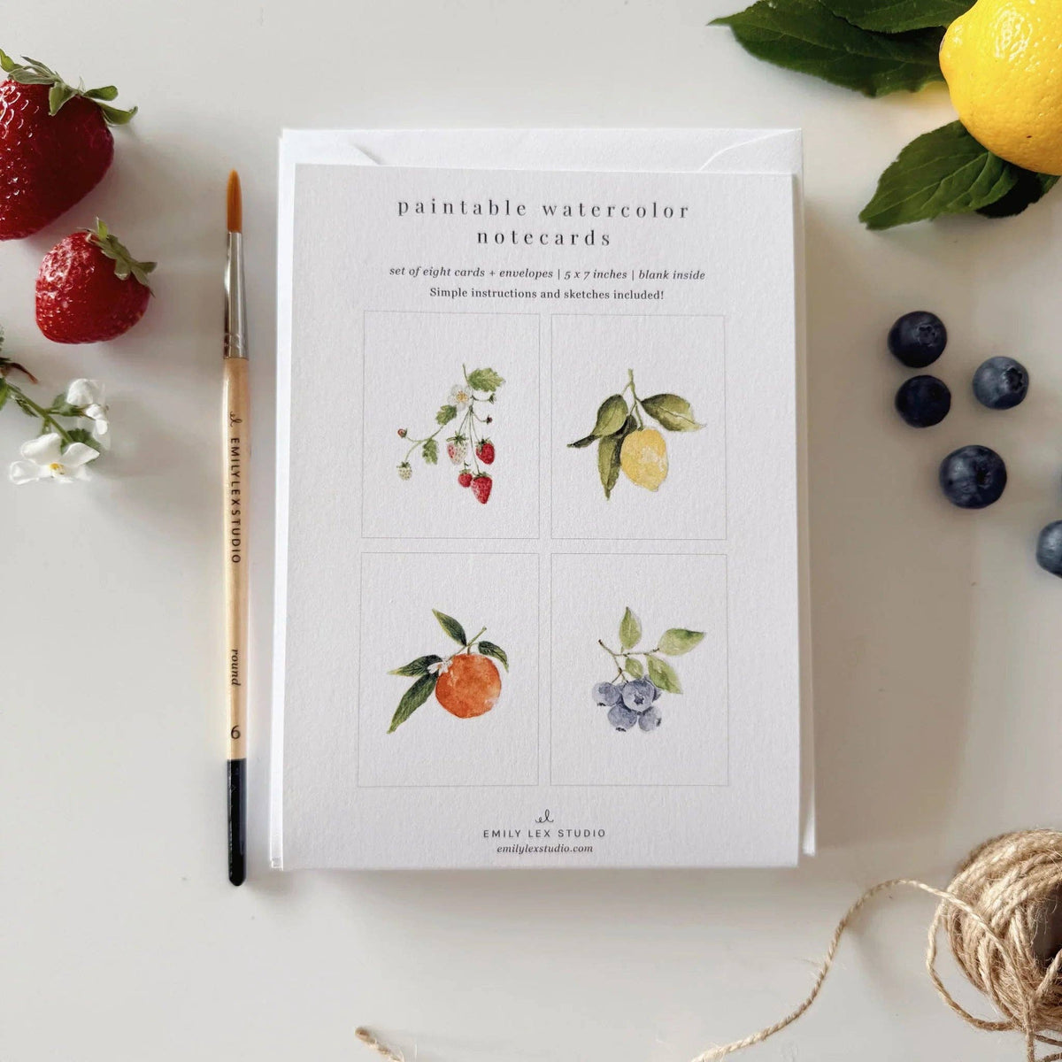 Paintable watercolor notecard set with 4-panel fruit illustrations on white cards.