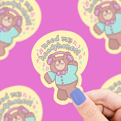 Vinyl sticker of a bear wearing headphones with pastel text, rounded die-cut