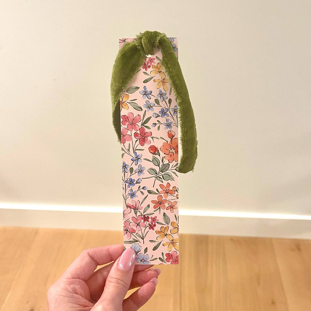 Floral double-sided bookmark side view with multicolor blooms and green velvet ribbon loop