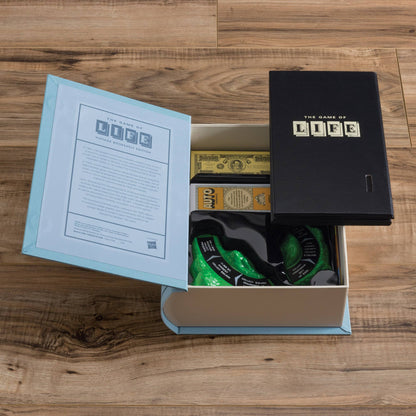Game box open with instruction booklet, money, and green token pieces