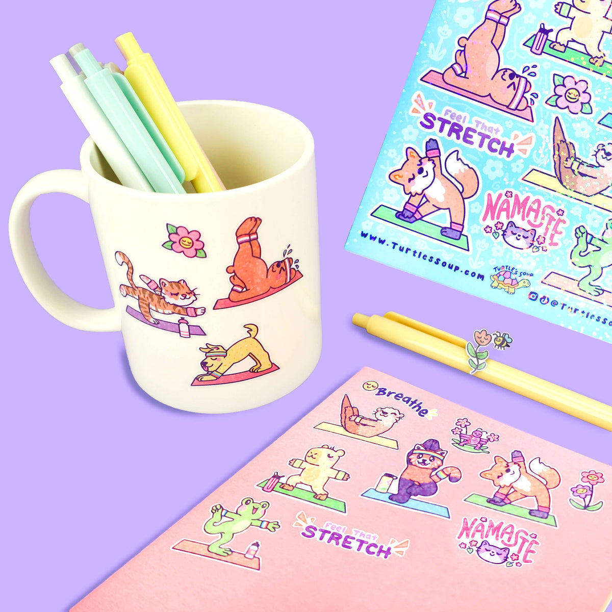 Yoga animal sticker sheet with colorful workout poses, shown beside pen and mug