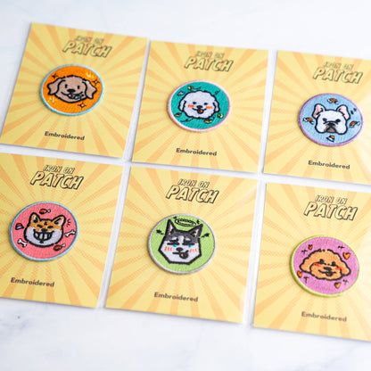 Six-pack of round embroidered dog iron-on patches on yellow cards
