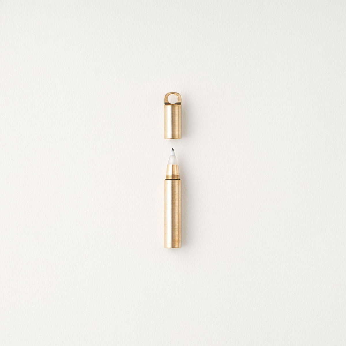 Gold-capped refillable travel pen with pale metallic barrel and open tip