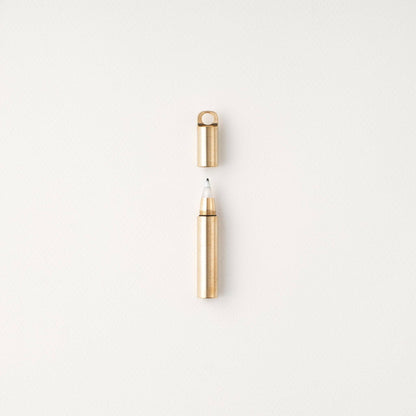 Gold-capped refillable travel pen with pale metallic barrel and open tip