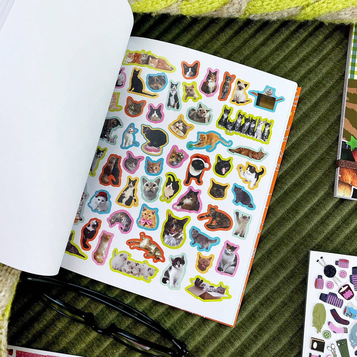 Cat sticker book page with light background and many assorted cat sticker shapes