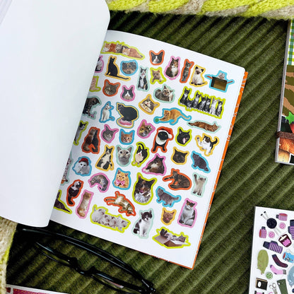 Cat sticker book page with light background and many assorted cat sticker shapes