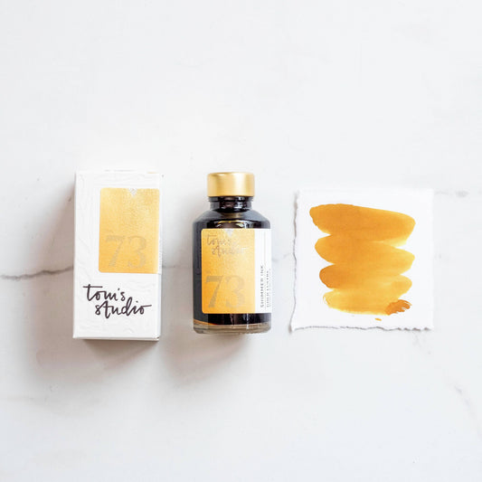 Gold shimmer ink bottle with matching ink swatch cards, Golden Lustre