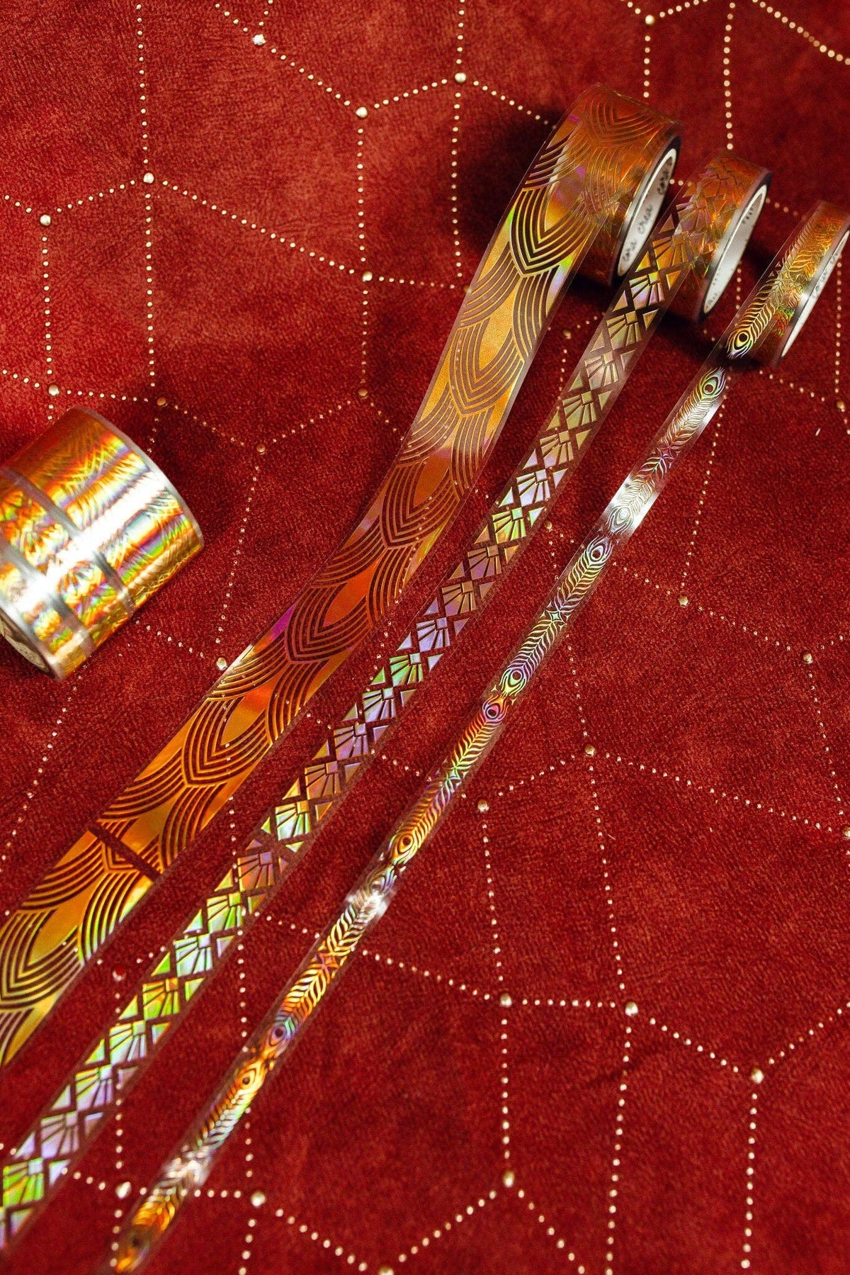 Set of gold art deco patterned transparent tape rolls, with multiple ribbon strips