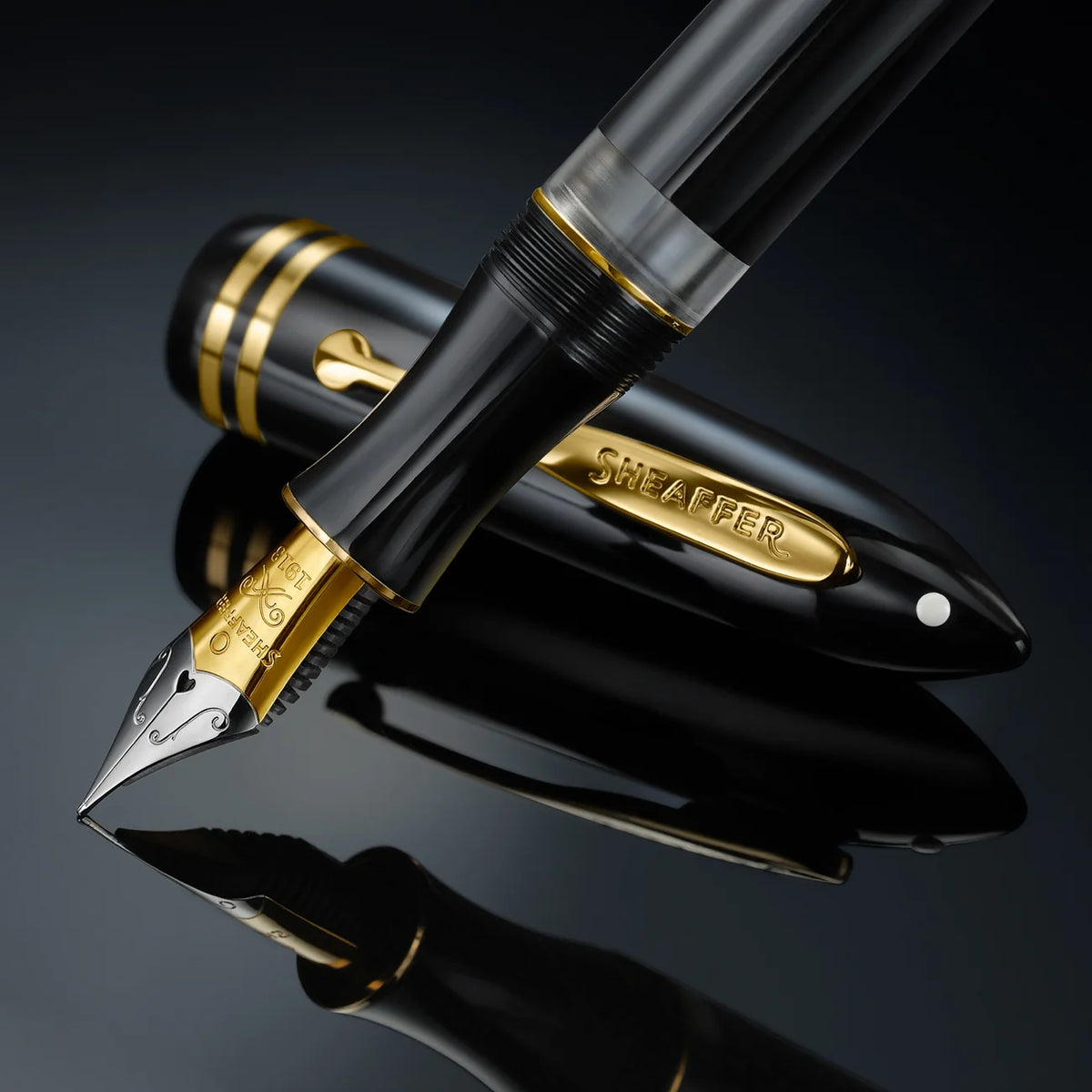 Black fountain pen close-up with gold nib and barrel detailing