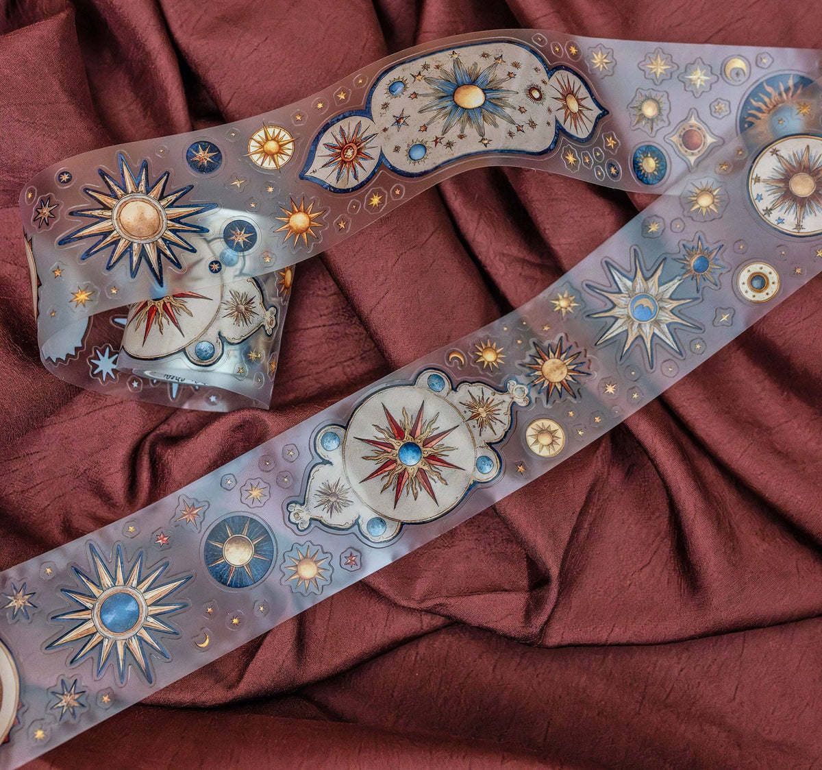 Astronomy transparent tape strip with blue planet and star motifs, gold accents