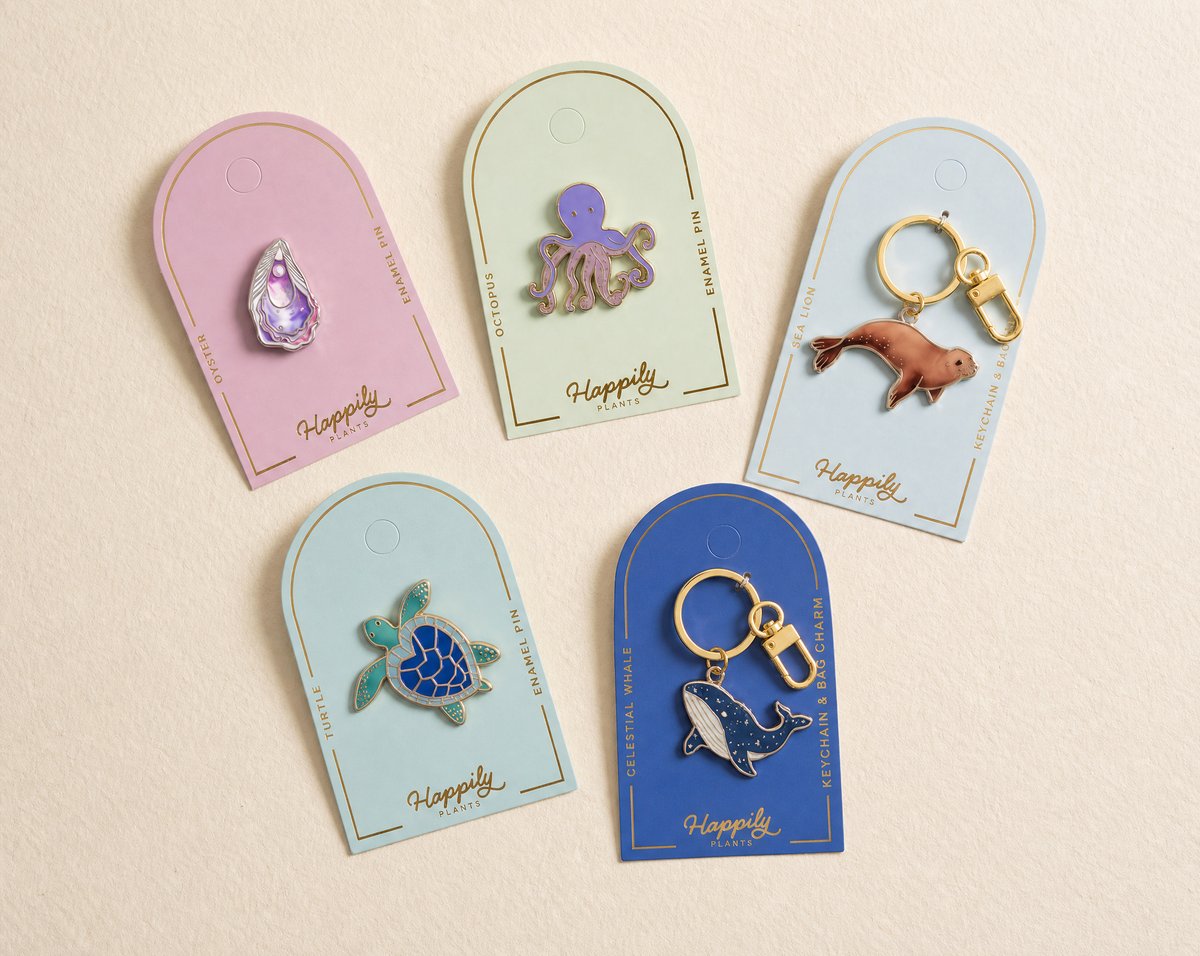 Set of assorted enamel animal pins on display cards