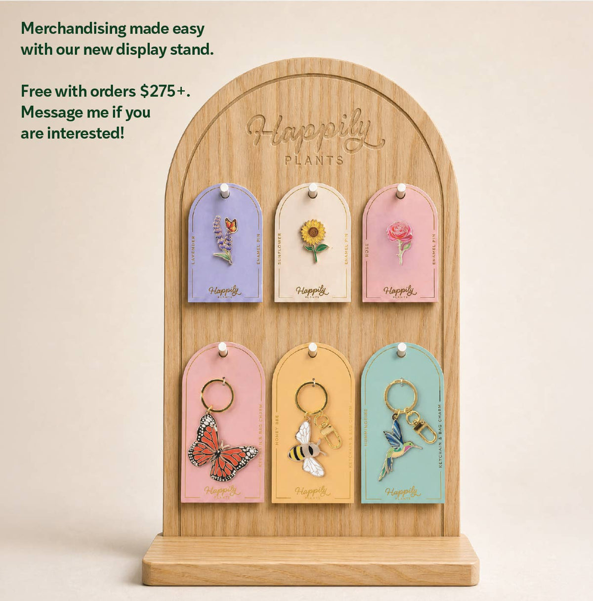 Wood display stand with multiple carded pins, including a hummingbird pin.