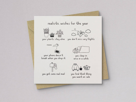 Letterpress year wish card with doodle icons, layered over kraft envelope
