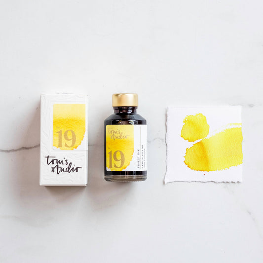 Fountain pen ink set with lemon yellow ink bottle, box, and ink color swatch