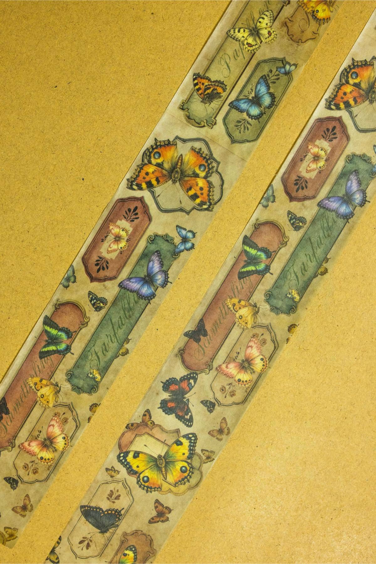 Butterfly-pattern washi tape with repeating colorful insect illustrations along the strip