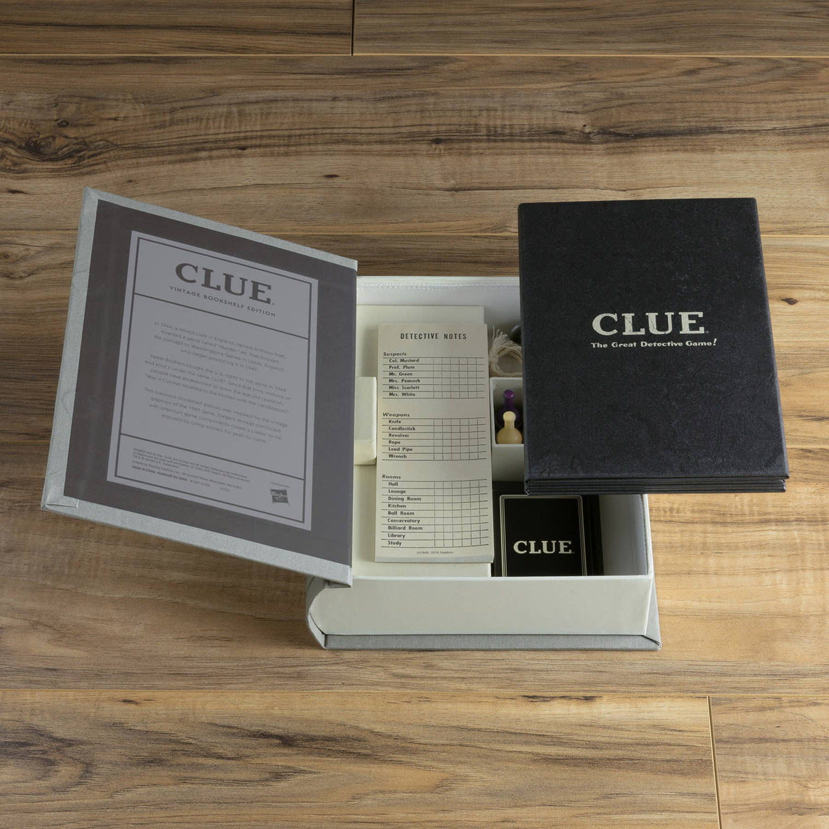 Clue game set with open box, instruction booklet, and black game case