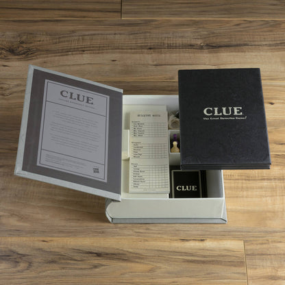 Clue game set with open box, instruction booklet, and black game case